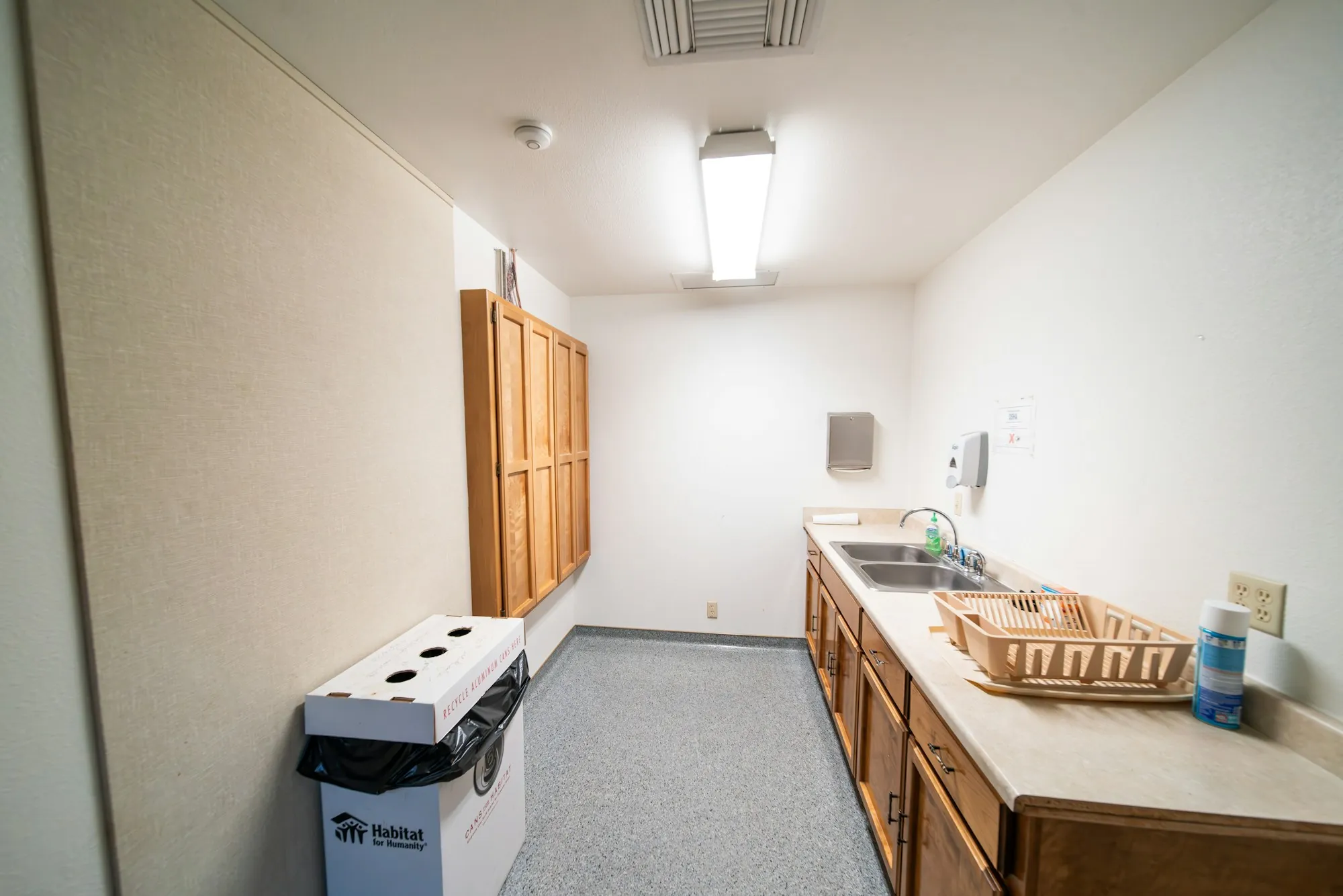 Small office kitchenette with a recycling bin
