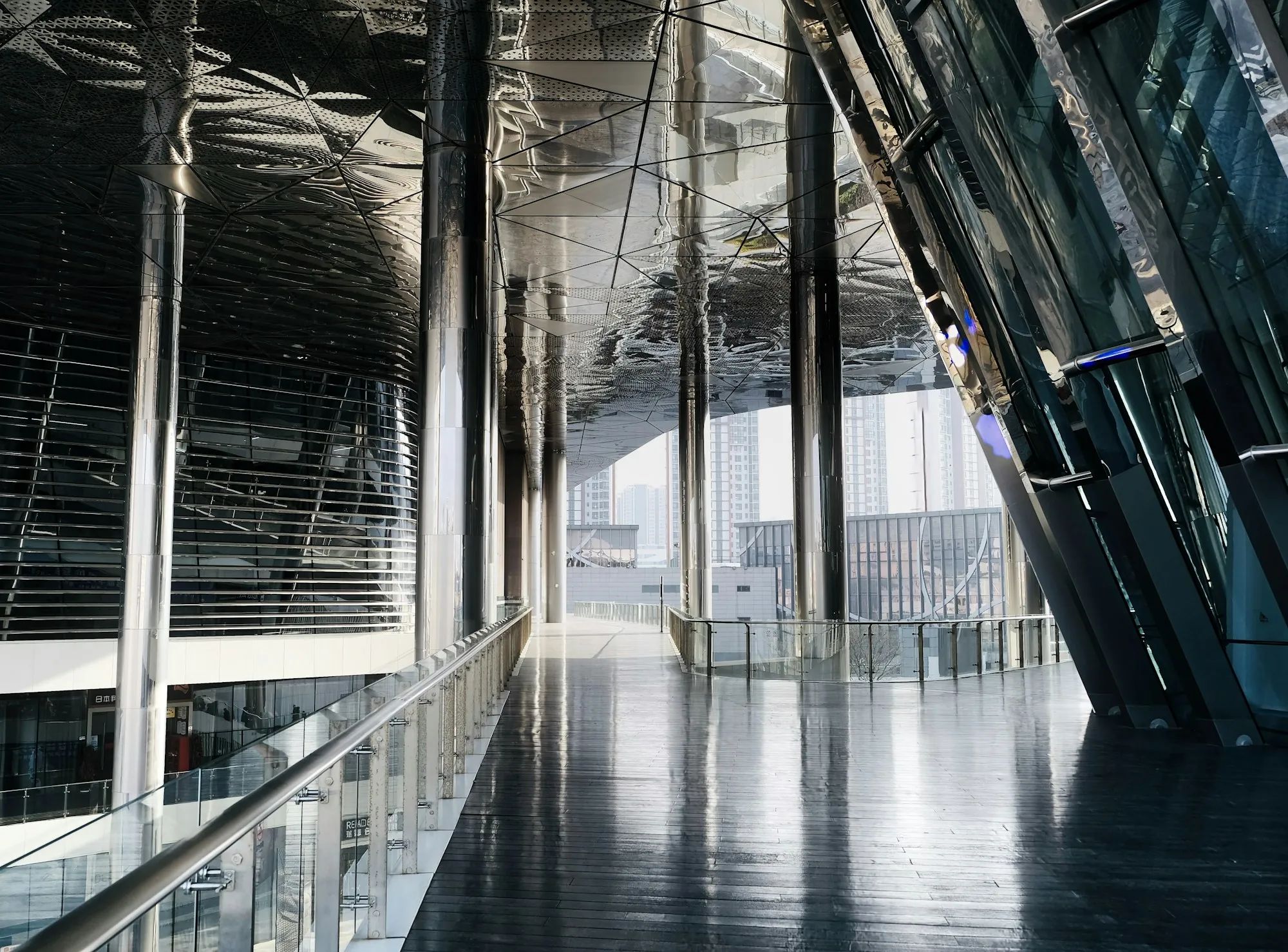 Glass corridor with a reflective polished floor